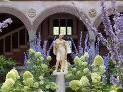 Grecian statue with purple flowers